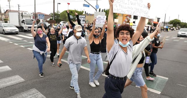 Protesters march in Cerritos — and invite sheriff’s deputies to join them