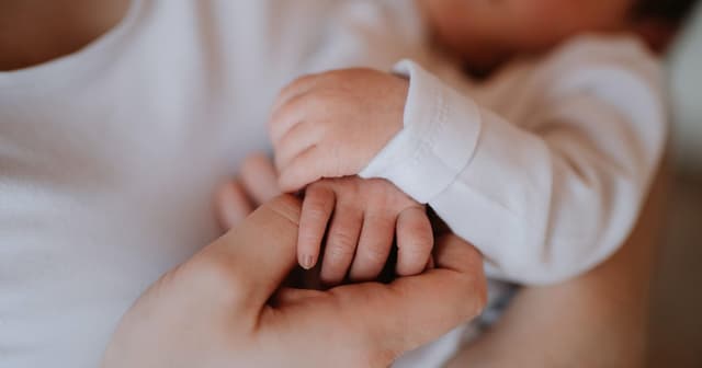 The measles outbreak is "slowing." A newborn's family still can't meet her.