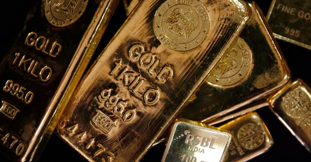 Gold gains as oil slide cools some inflation concerns